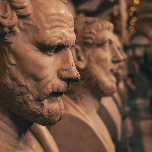 Row of human statue busts of historical men.